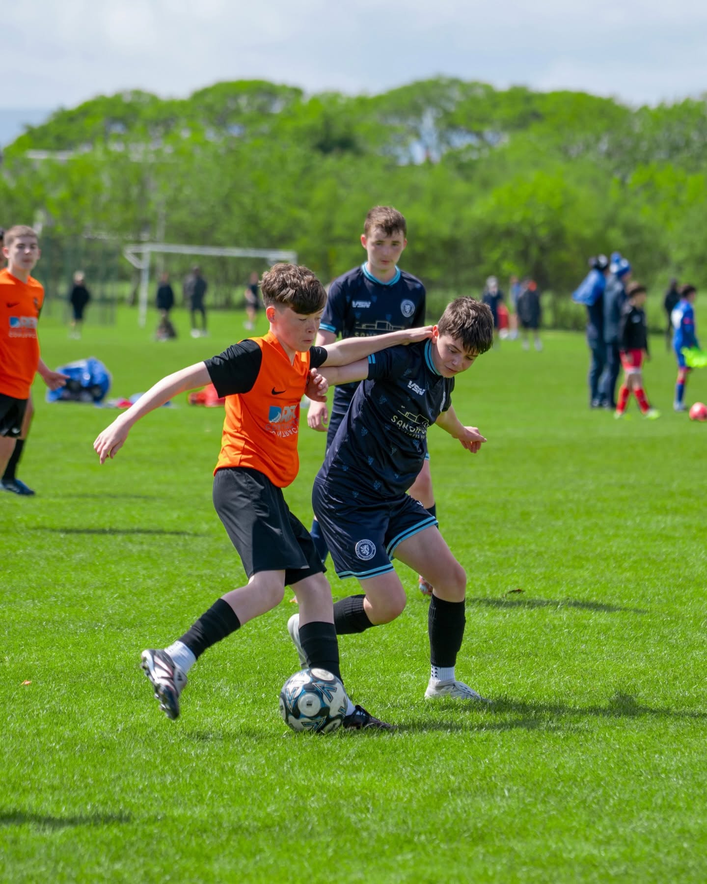 Young footballers competing for the ball during a youth match